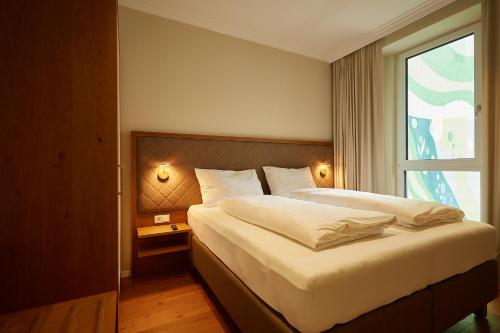 a bedroom with a large bed and a window at Green Leisure Apartments Schweglerstrasse in Vienna