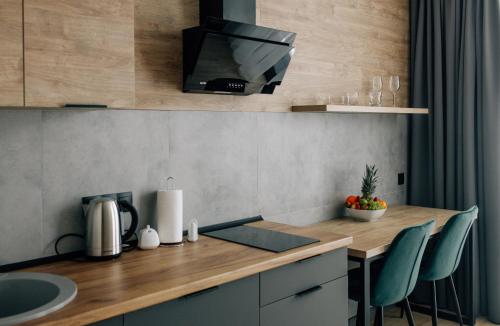 a kitchen with a counter with a tv on the wall at Rest&Ski Spa Resort in Bukovel