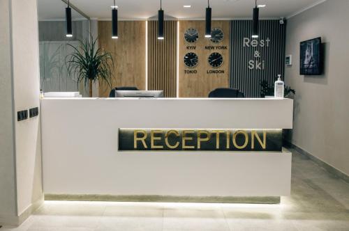 a reception desk in a lobby with a reception sign at Rest&Ski Spa Resort in Bukovel
