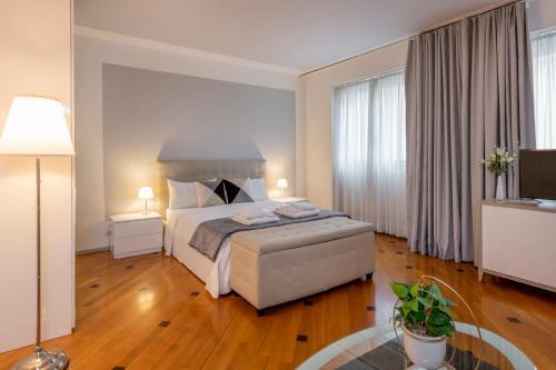 a hotel room with a bed and a television at Milan Royal Suites - Centro in Milan