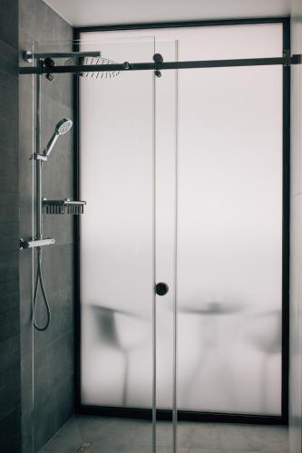 a shower with a glass door in a bathroom at Rest&Ski Spa Resort in Bukovel