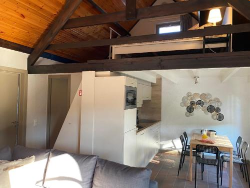 a living room with a couch and a table with chairs at vakantiehuisje 003 in Koksijde