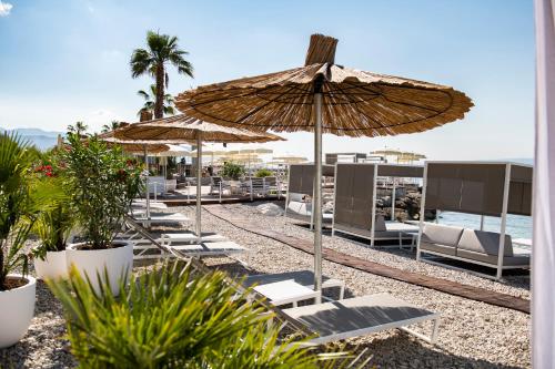 a group of chairs and umbrellas on a beach at Radisson Blu Resort & Spa in Split