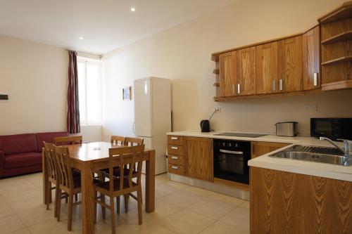 a kitchen with a table and chairs and a refrigerator at SC Club Village in Pembroke 