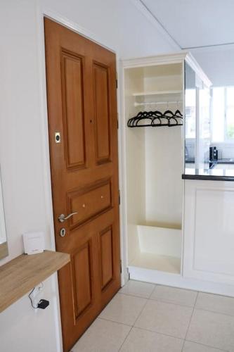 a room with a door and a kitchen with a stove at Superior Double Room with Stunning Sea View. DT in Patra