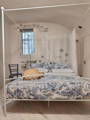a white bed with a canopy in a bedroom at Casa Roberta in Dolceacqua