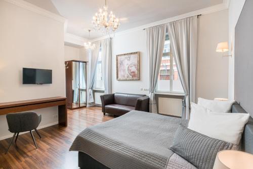 a hotel room with a bed and a chair at Hotel Aurora in Wiesbaden