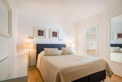 a bedroom with a bed in a white room at Hotel Aurora in Wiesbaden