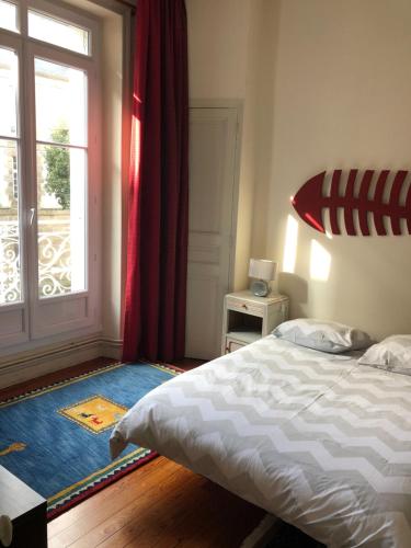 a bedroom with a bed and a large window at ville Pépin in Saint Malo