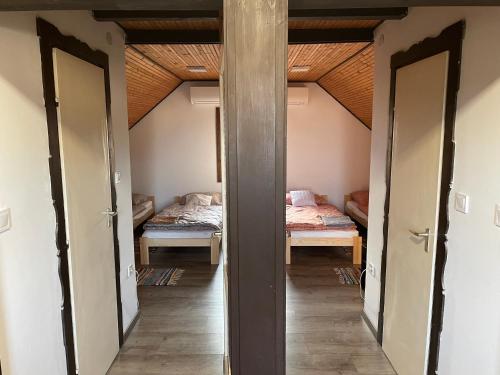 a hallway with two beds in a room at Perényi Pince és Vendégház Hajós in Hajós