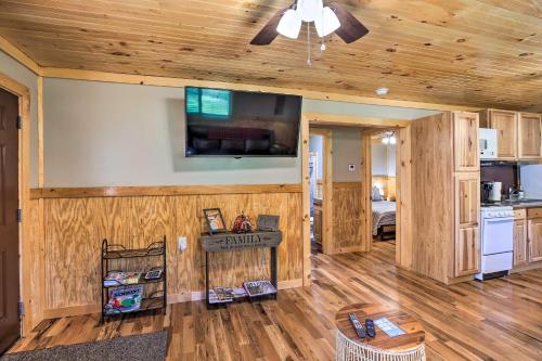 a kitchen and living room with wooden walls and a ceiling at Silver Creek Cabin with Hiking Less Than 1 Mi to Town! in Beattyville