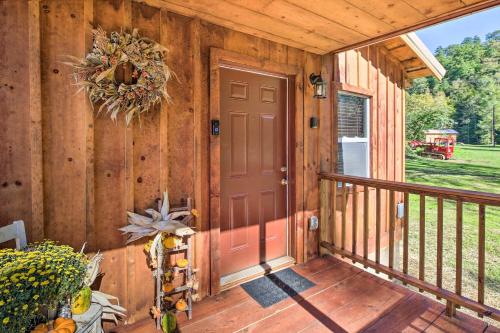 a porch of a wooden cabin with a door at Silver Creek Cabin with Hiking Less Than 1 Mi to Town! in Beattyville