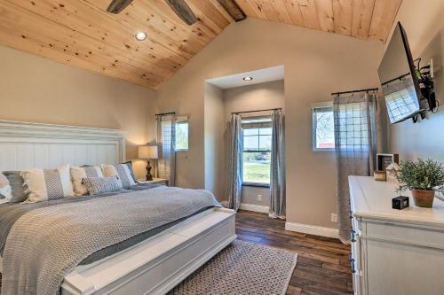 a bedroom with a large bed and wooden ceilings at Chic Williamstown Retreat with Pool and Hot Tub! in Williamstown
