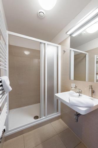 a bathroom with a shower and a sink at Apartmány Rokytka Snowhouse in Rokytnice nad Jizerou