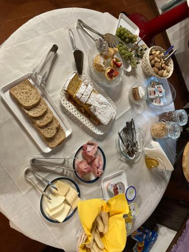 a table with a white table cloth with food on it at Villa Lioy-Faresin in Montegalda