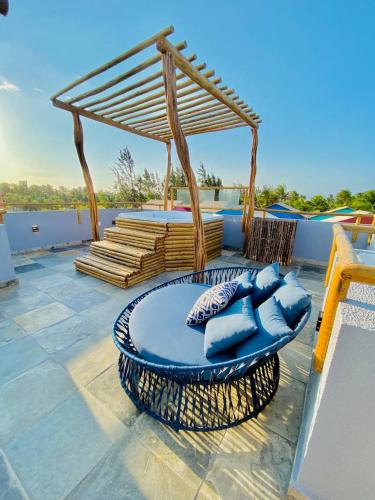 a patio with blue chairs and a gazebo at Pousada Sole - D3 Experience - Preá, CE in Prea