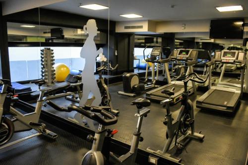 a gym with several treadmills and cardio machines at Savoy Hotel in Buenos Aires