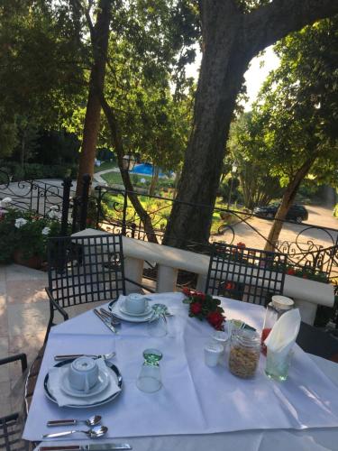 a table with plates and utensils on top at Villa Lioy-Faresin in Montegalda