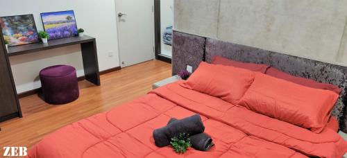 a bedroom with a large bed with red pillows at i-City-Casa Joy - Wifi, Netflix - Movies, Parking, Sleeps 7 Pax in Kampong Padang Jawa