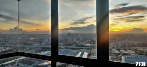 a view of a city skyline from an office window at i-City-Casa Joy - Wifi, Netflix - Movies, Parking, Sleeps 7 Pax in Kampong Padang Jawa