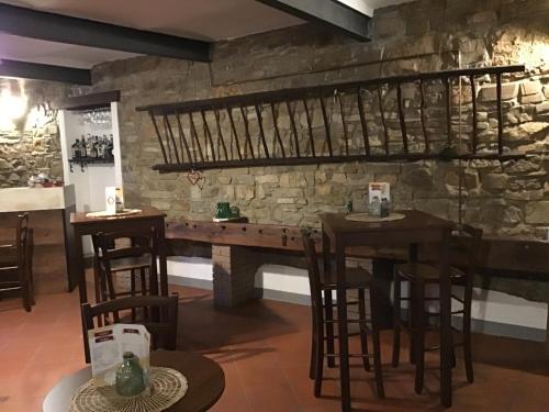 a restaurant with a stone wall and tables and chairs at Agriturismo Cà di Matt in Mongiardino Ligure