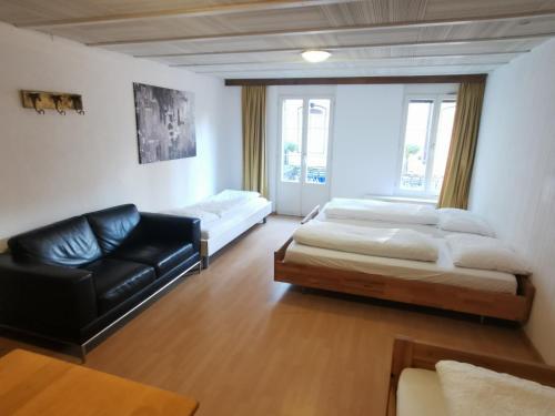 a living room with two beds and a couch at Linda Apartment 33 in Interlaken