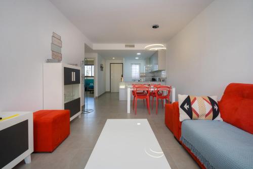 a living room with a couch and a table at Kokopelli in San Juan de los Terreros
