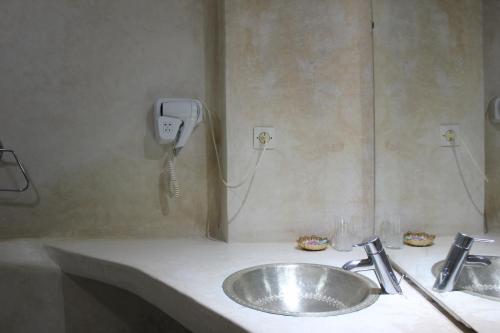 a bathroom with a sink and a phone on the wall at Riad Jnan El Cadi in Marrakech