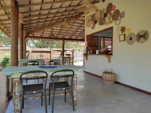 a dining room with a table and chairs in a house at Pousada Vila Cacau in Serra Grande