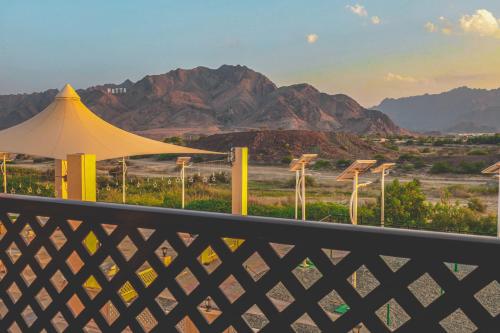 a balcony with a view of the desert and mountains at Hatta Guest House in Hatta