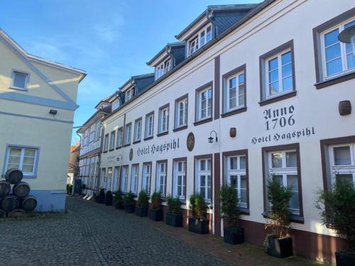 a row of white buildings on a street at Hotel Hagspihl in Quakenbrück
