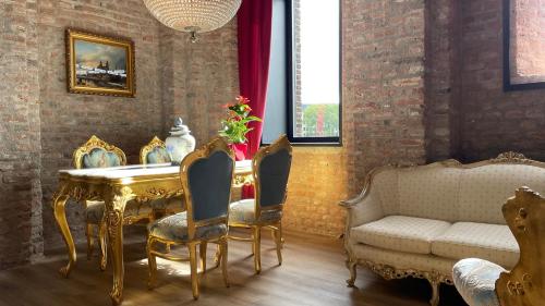 a living room with a table and chairs and a couch at Walburgis Residenties in Arnhem