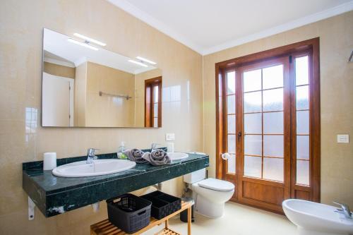 a bathroom with a sink and a toilet and a mirror at Villa Amana 5 star luxury resort for 10 people in Playa Blanca in Playa Blanca