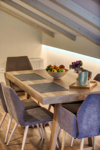 a wooden table with a bowl of fruit on it at Giataki in Elati Trikalon