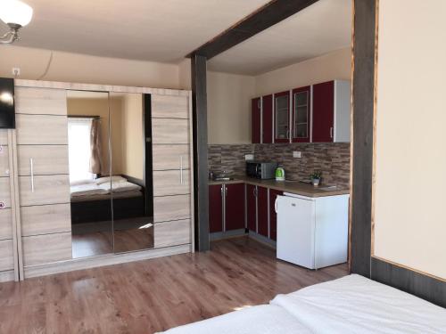 a kitchen with a sliding glass door leading to a bedroom at Penzion u Šmídů Náměstí in Jaroslavice