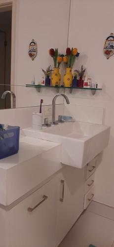 a white bathroom with two sinks and a mirror at Cantinho familiar-Humaitá - somente mulheres - just women in Rio de Janeiro