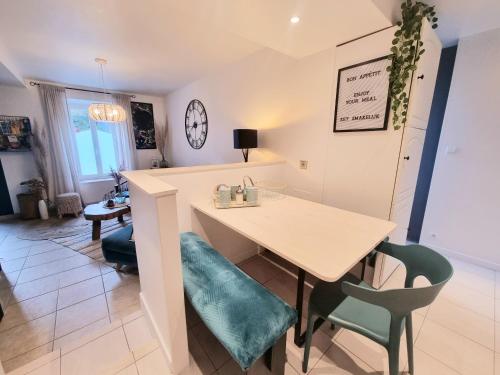 a kitchen and dining room with a table and chairs at La Tiny proche lac et forêt in Sillé-le-Guillaume