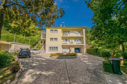 an apartment building with a large driveway at Apartments Anita near Opatija with private parking in Matulji
