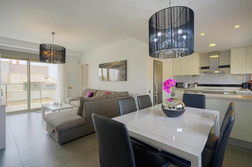 a kitchen and living room with a table and a couch at Vistabella in Orihuela Costa