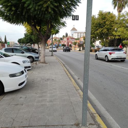 a street with cars parked on the side of the road at Hospedaje Benacazon A49 in Benacazón