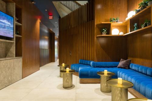 a lobby with a blue couch and some tables at Hotel Stratford in San Francisco