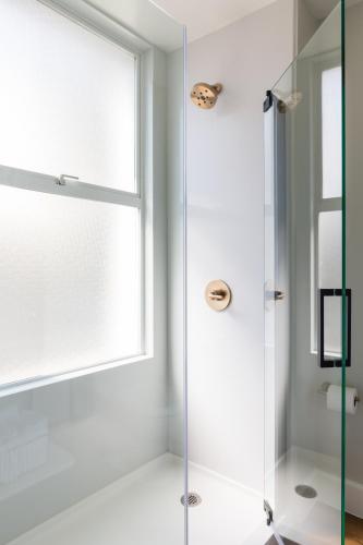 a shower with a glass door in a bathroom at Hotel Stratford San Francisco - Handwritten Collection in San Francisco