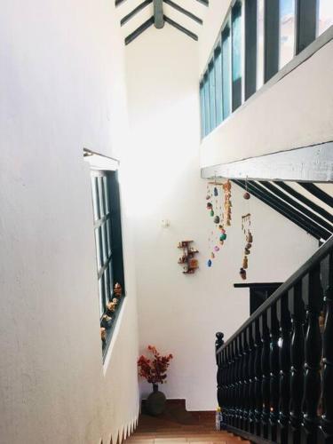 a hallway of a house with a staircase and a window at Casa Familiar Central Villa Diana in Villa de Leyva