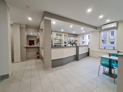 a large room with a kitchen and a table at hotel city 20 in Milan
