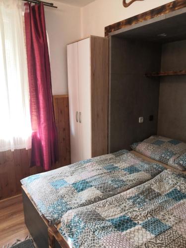 a bedroom with a bed with a quilt on it at Penzion u Šmídů Náměstí in Jaroslavice