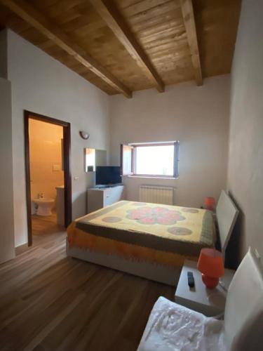 a bedroom with a bed and a desk in a room at BORGO DON ARMANDO - Appartamento A B C E in Francavilla in Sinni