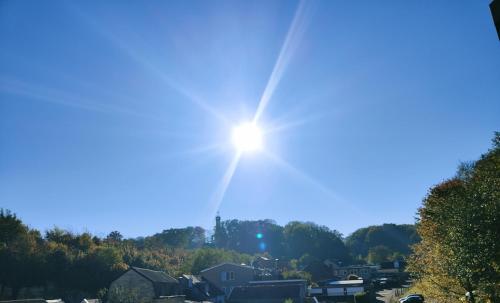 a sun shining in the sky over a town at Hotel B&B LeLa in Valkenburg