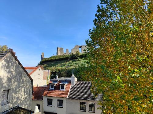 a castle on top of a hill with buildings at Hotel B&B LeLa in Valkenburg