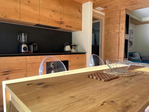 a kitchen with a wooden table with a counter top at Chalet Lilla Livigno in Livigno
