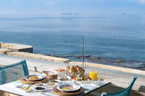 a table with food on it with a view of the ocean at Akotika boutique in ‘Akko